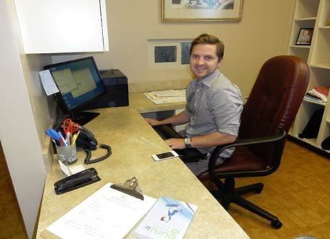 Adam Densley works to set up the front office of the clinic.