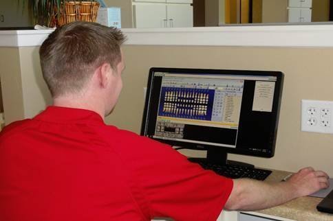 Martin Gubler loads software at clinic workstations.