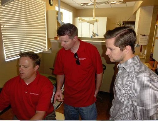 Marc Blaser (left), Martin Gubler (middle), and Adam Densley (right) work to finalize the installation of software.